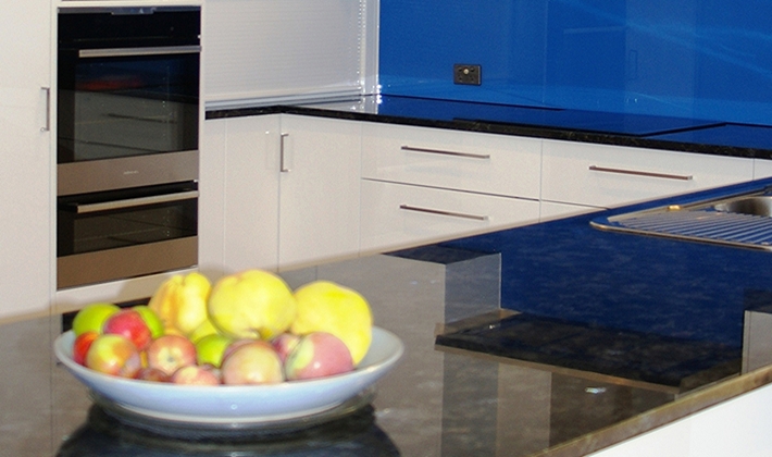 A Modern Black and White Kitchen with a strong accent colour which pick up on the Blues in the Peacock Pearl Granite, by Compass Kitchens of Adelaide